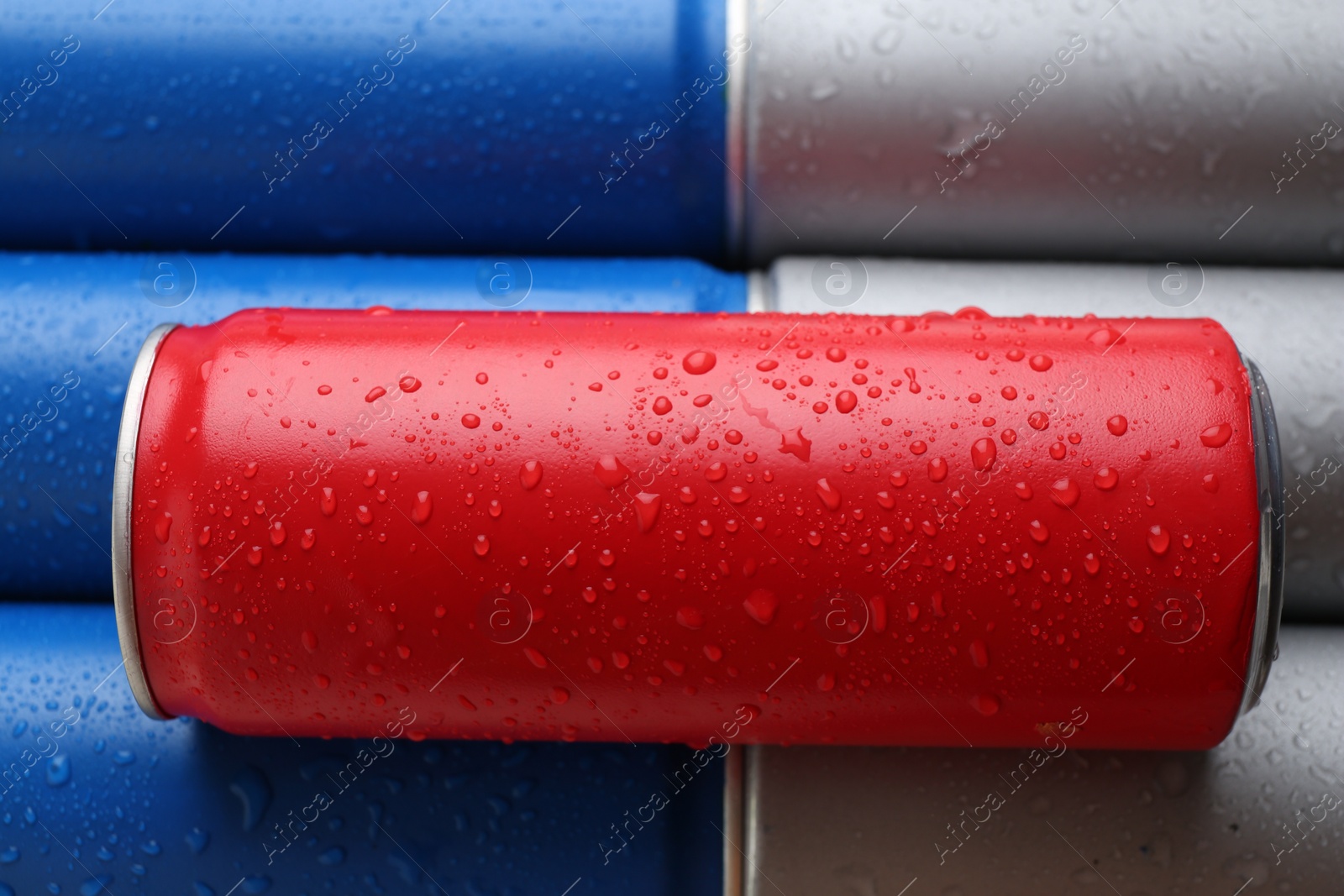 Photo of Energy drinks in wet cans as background, closeup view