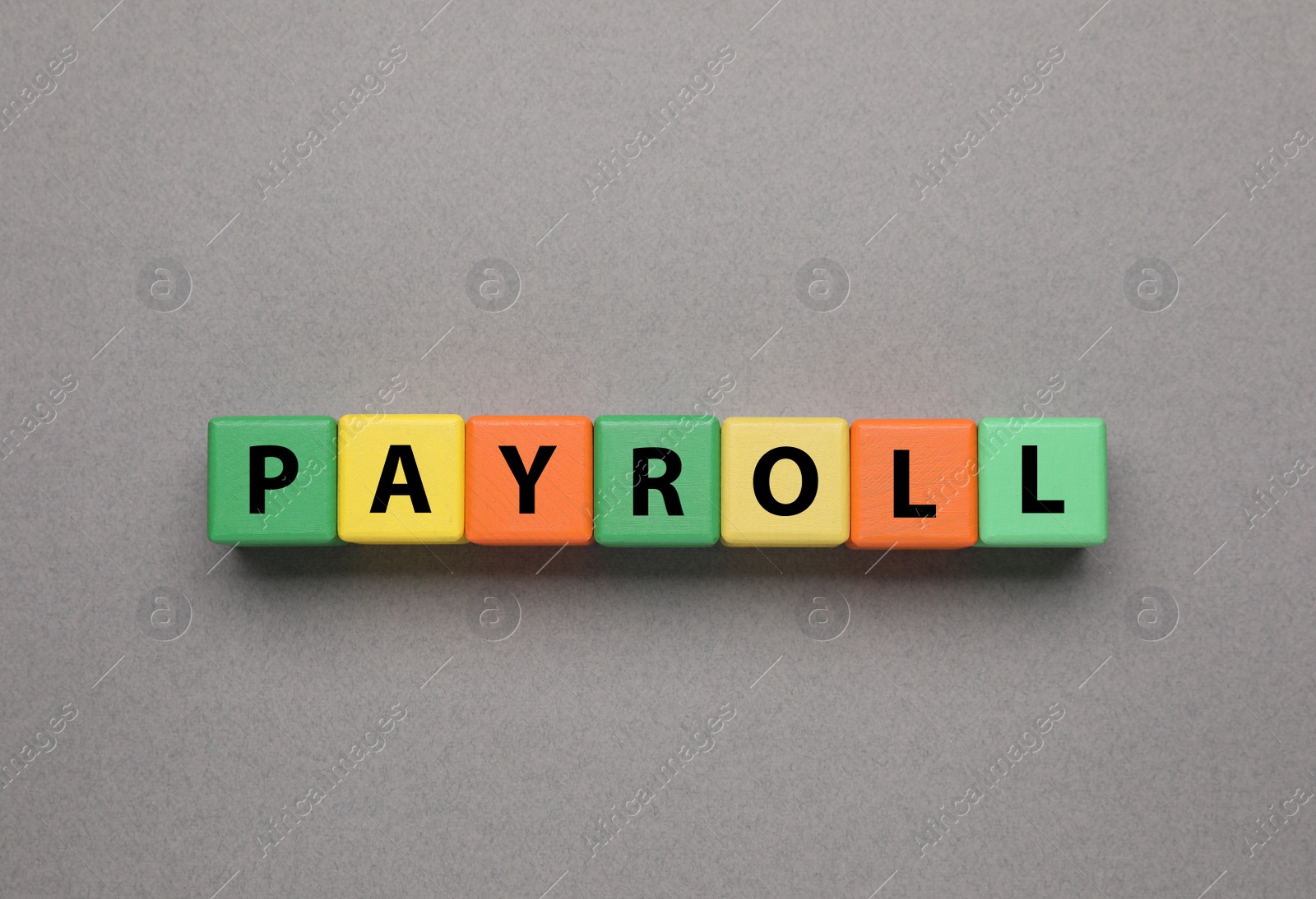 Photo of Word Payroll made of colorful wooden cubes with letters on grey background, top view