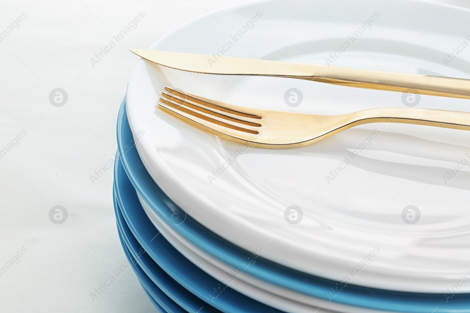 Photo of Stack of plates with fork and knife, closeup