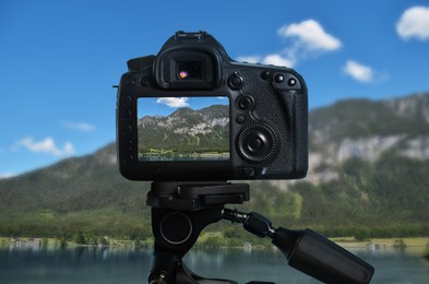 Image of Taking photo of beautiful mountain landscape with camera mounted on tripod