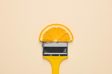 Photo of Creative flat lay composition with paint brush and orange slice on beige background