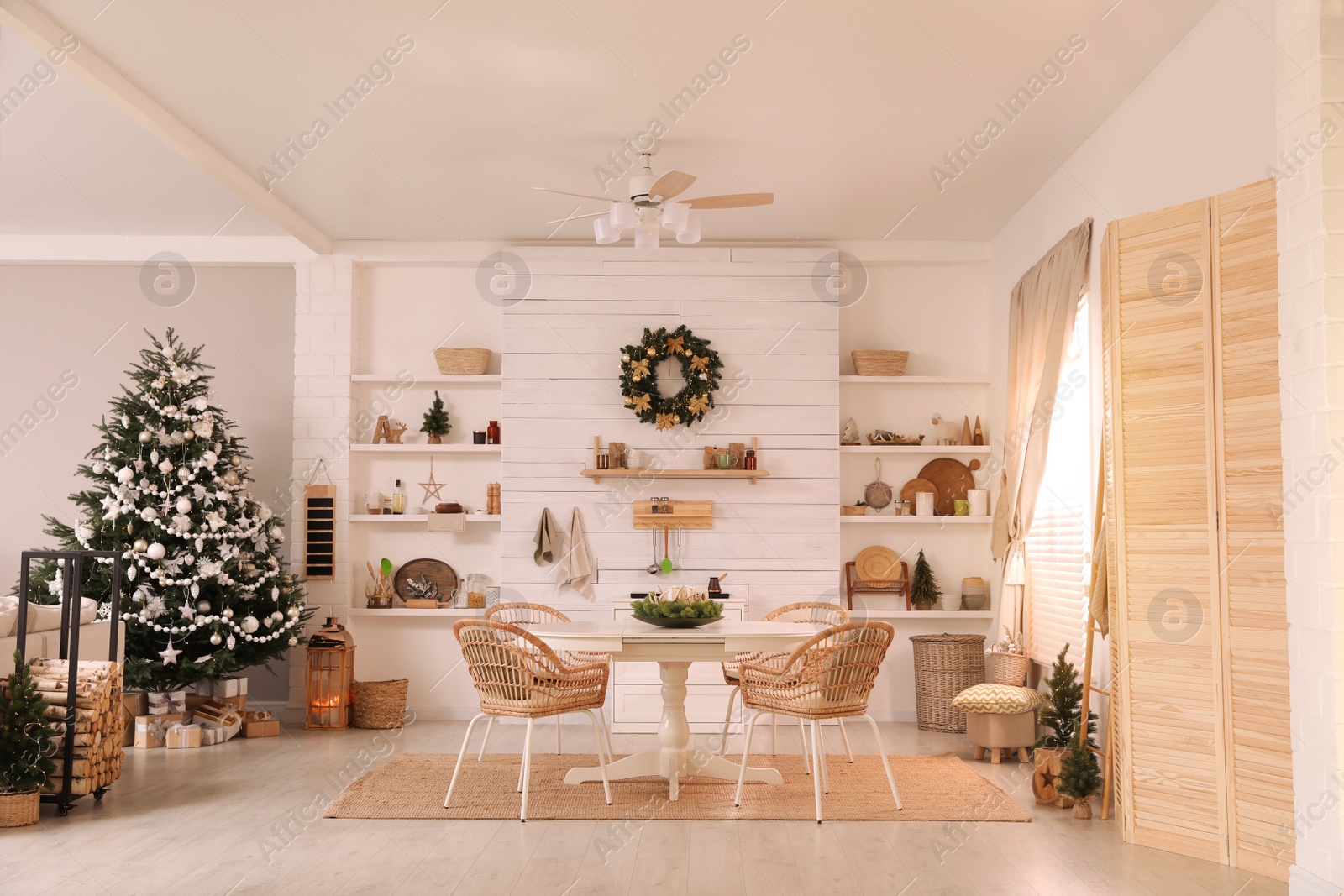 Photo of Cozy dining room interior with Christmas tree and festive decor