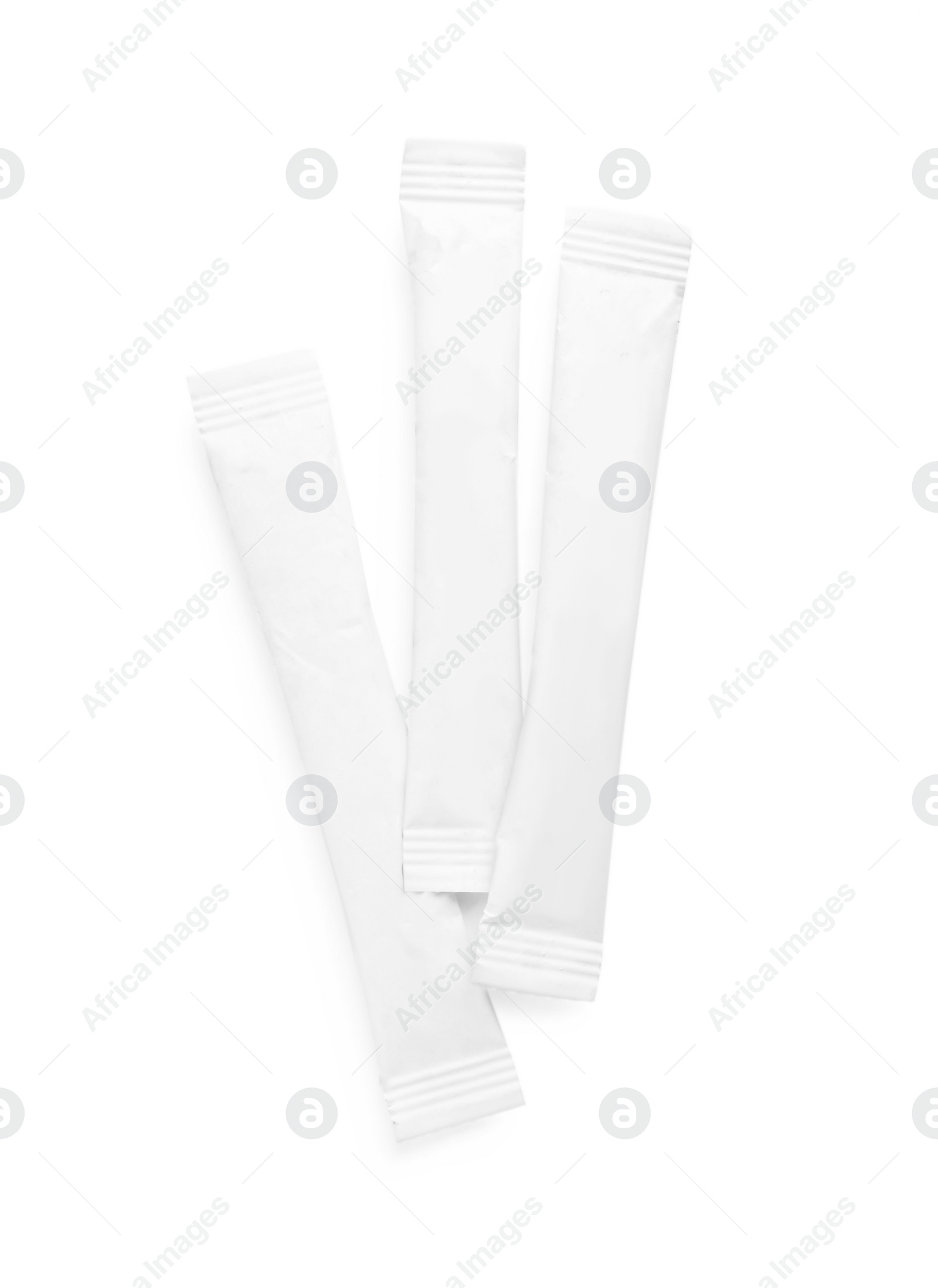 Photo of Paper sticks of sugar on white background, top view
