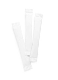 Photo of Paper sticks of sugar on white background, top view