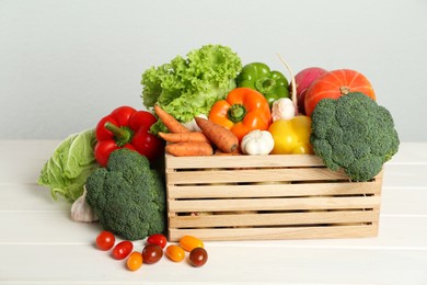 Photo of Assortment of fresh vegetables on white wooden table