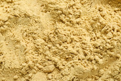 Photo of Aromatic mustard powder as background, top view