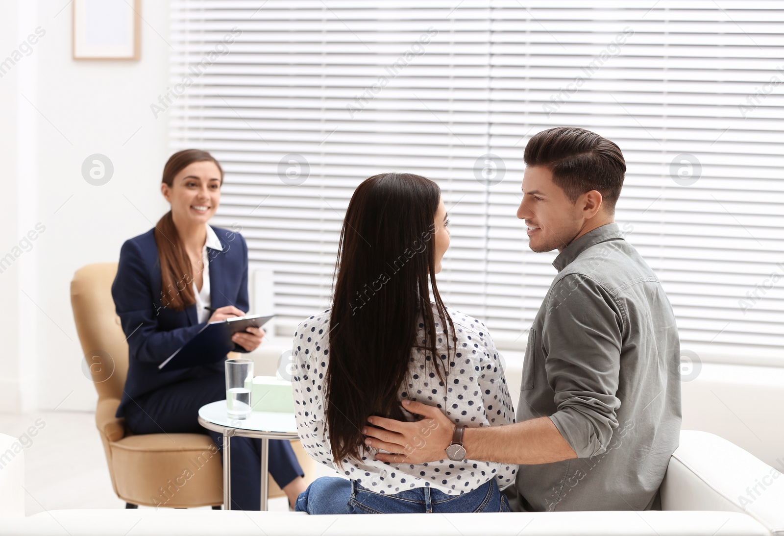 Photo of Professional psychologist working with couple in office