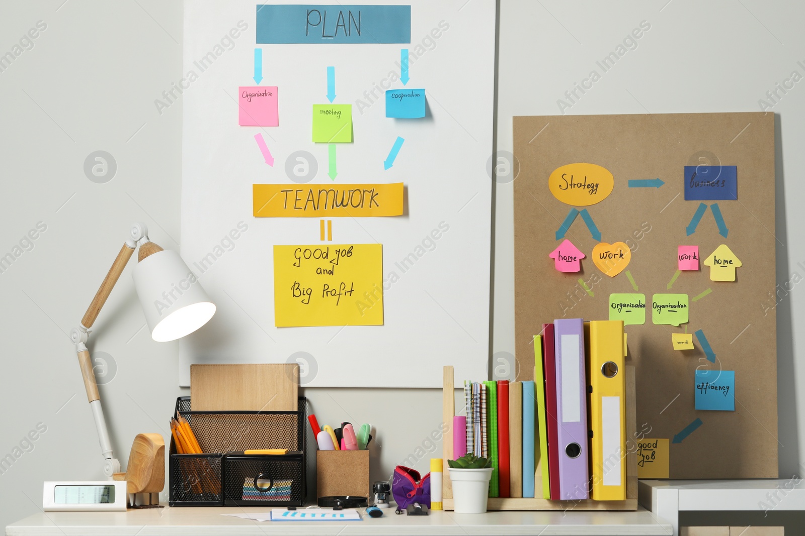 Photo of Business process planning and optimization. Workplace with lamp, colorful paper notes and other stationery on table