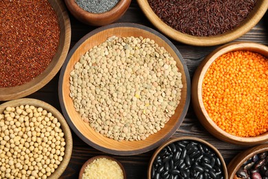 Photo of Different grains and seeds on wooden table, flat lay. Veggie diet