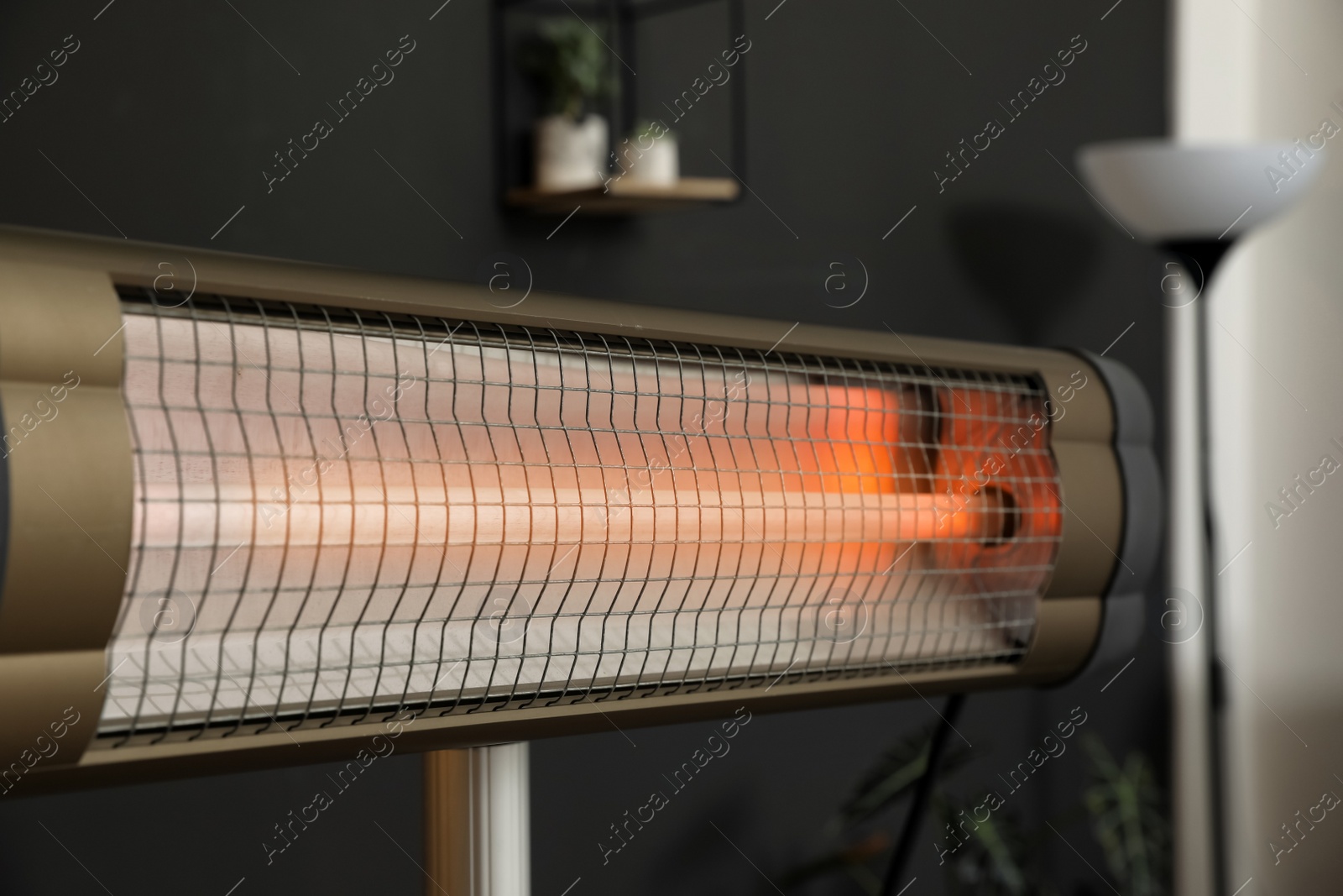 Photo of Modern electric infrared heater in room interior, closeup