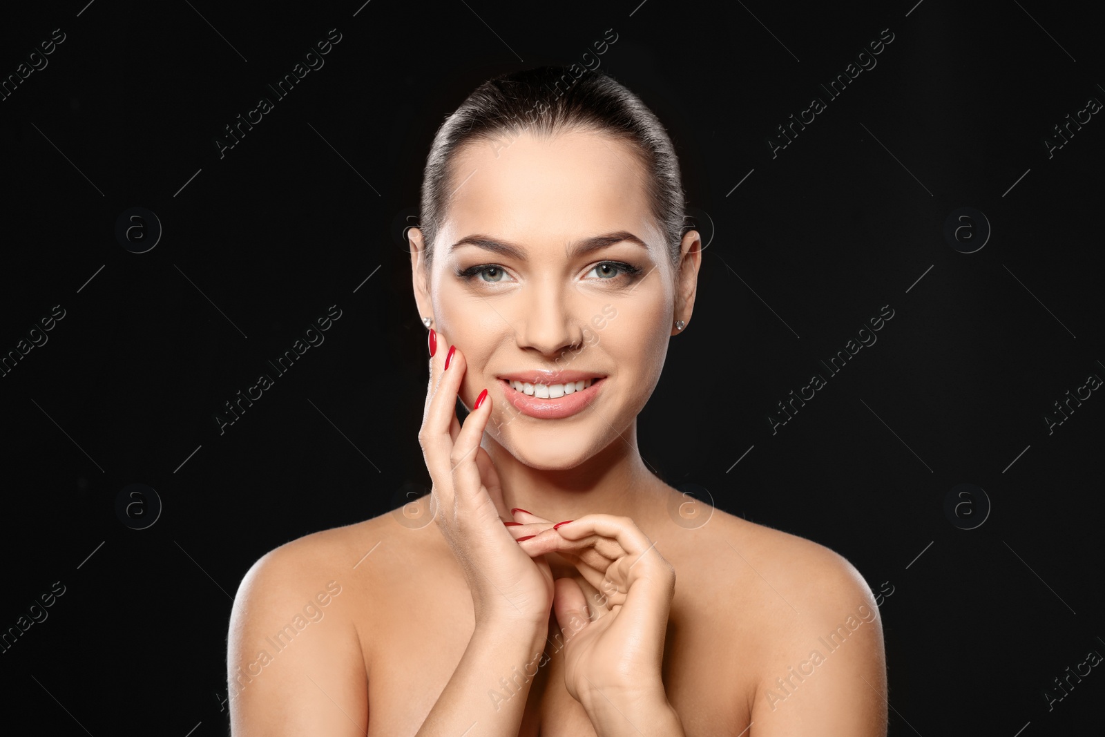 Photo of Portrait of beautiful young woman with bright manicure on black background. Nail polish trends