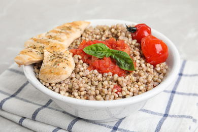 Photo of Tasty buckwheat porridge with meat on table, closeup