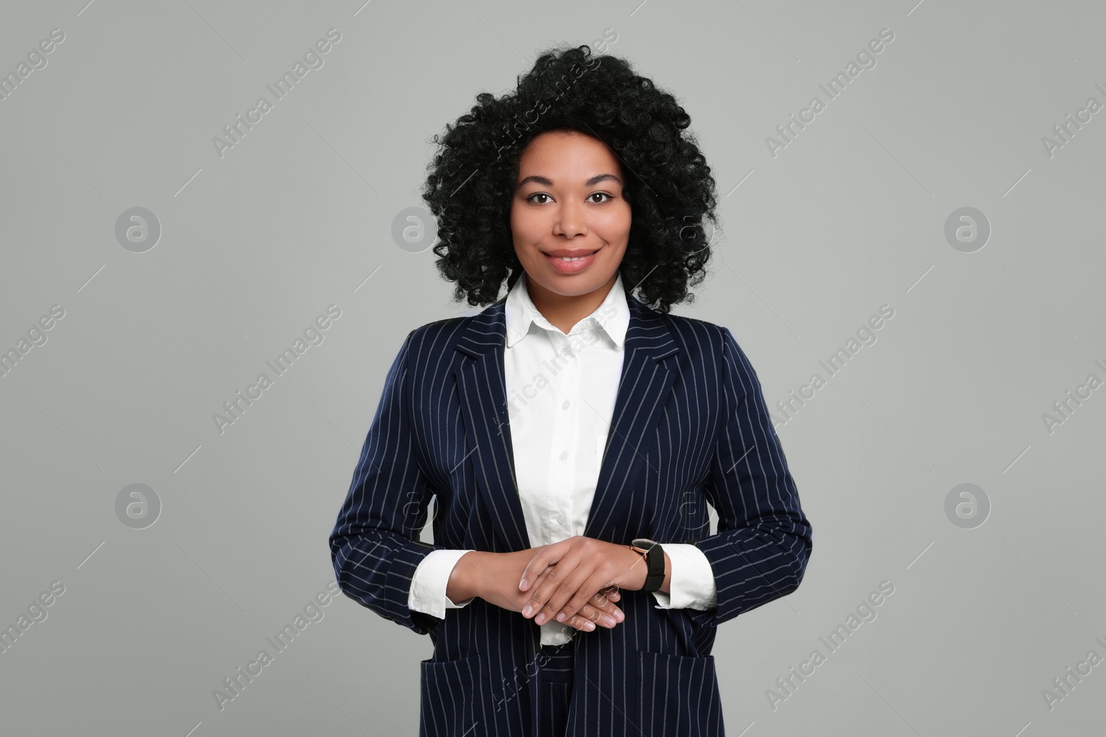 Photo of Young businesswoman in formal outfit on grey background