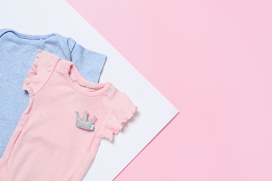 Cute baby clothes on color background, flat lay. Space for text