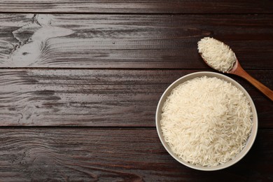 Photo of Raw basmati rice on wooden table, flat lay. Space for text