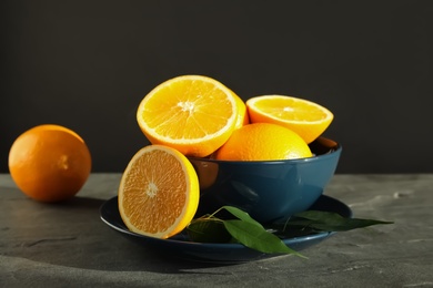 Fresh oranges in bowl on table. Healthy fruits