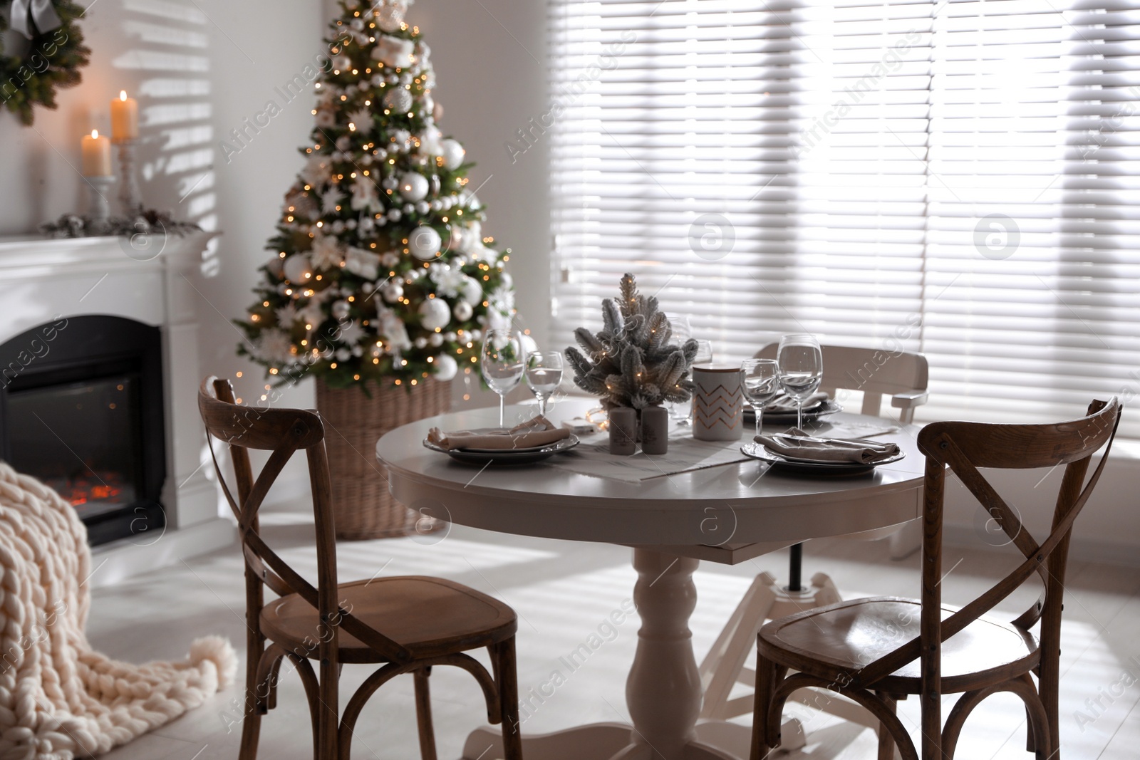 Photo of Festive table setting and beautiful Christmas decor in living room. Interior design