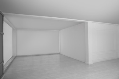 Empty room with white walls and laminated floor