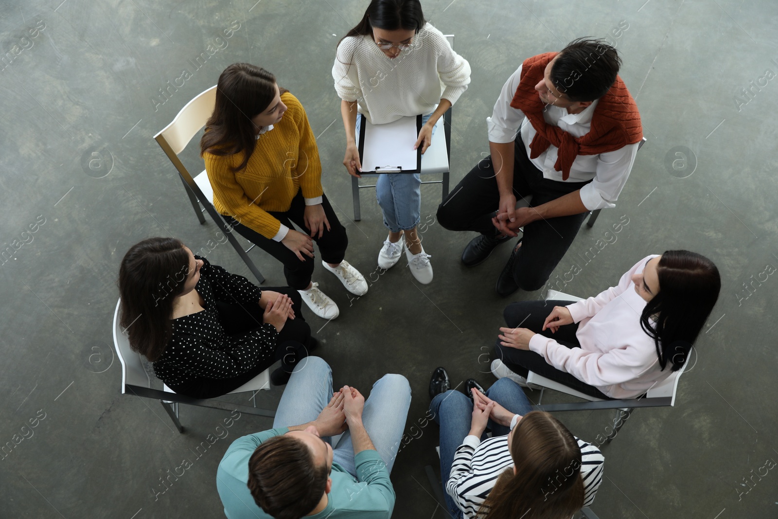 Photo of Psychotherapist working with patients in group therapy session, top view