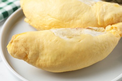 Photo of Pieces of fresh ripe durian on plate, closeup