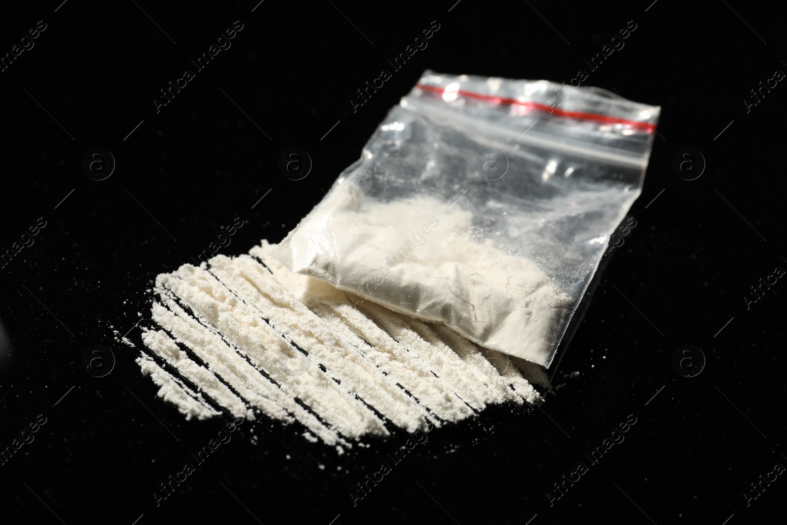 Photo of Drug addiction. Plastic bag with cocaine on black background, closeup