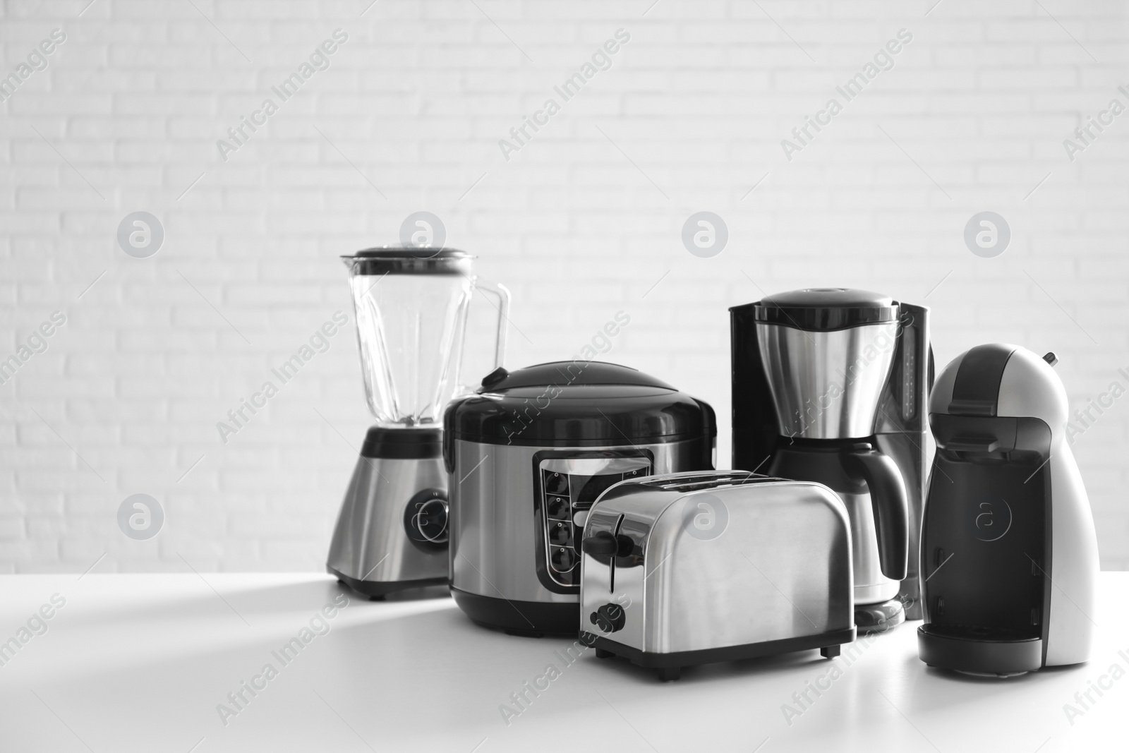 Photo of Set of modern home appliances on white table