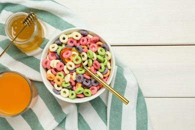 Photo of Bowl of sweet crispy corn rings, juice and honey on white wooden table, flat lay with space for text. Breakfast cereal