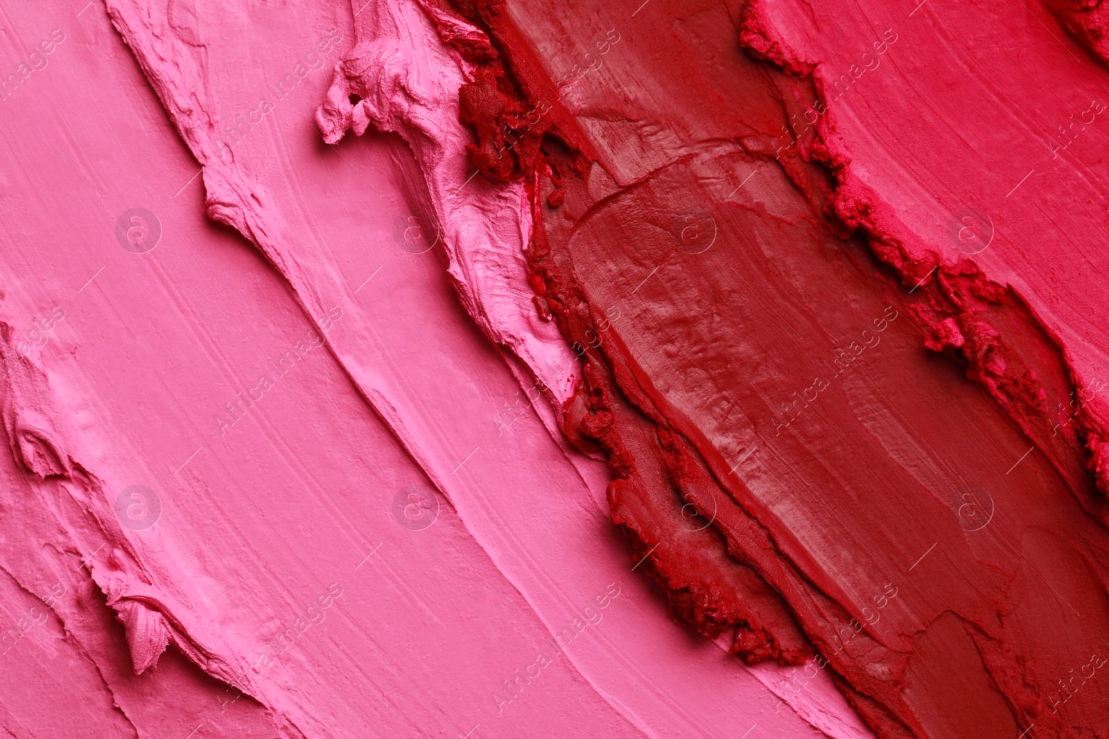 Photo of Texture of beautiful lipsticks as background, top view