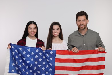 4th of July - Independence Day of USA. Happy family with American flag on white background