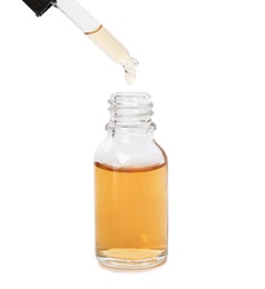 Photo of Bottle and dropper with essential oil on white background