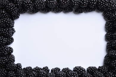 Photo of Frame of ripe blackberries on white background, flat lay. Space for text