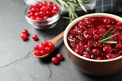 Photo of Cranberry sauce in bowl on dark grey table