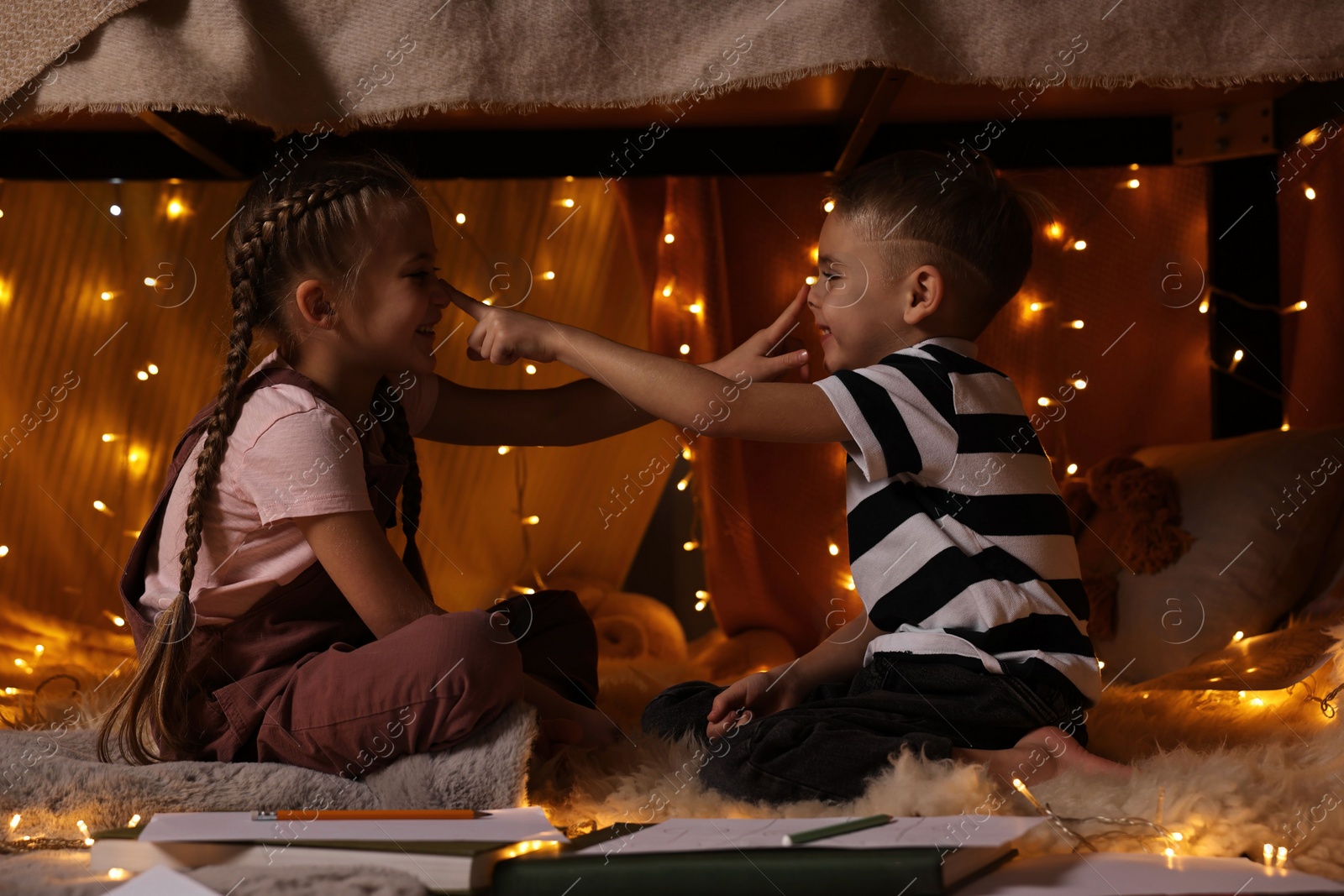 Photo of Children playing in play tent at home