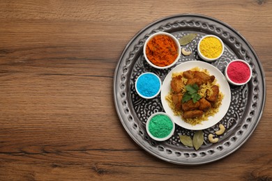 Photo of Traditional Indian food and color powders on wooden table, top view with space for text. Holi festival celebration