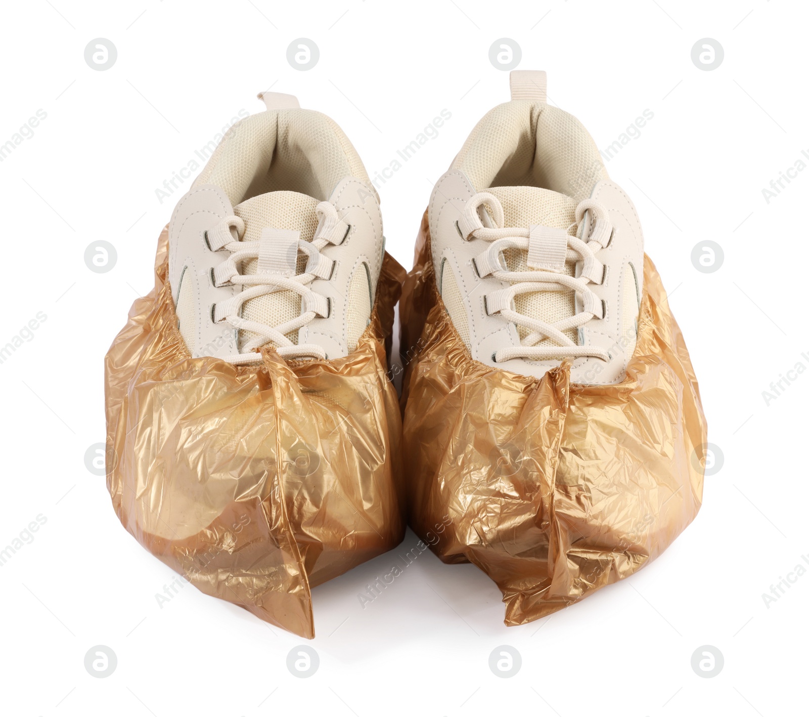 Photo of Sneakers in brown shoe covers isolated on white