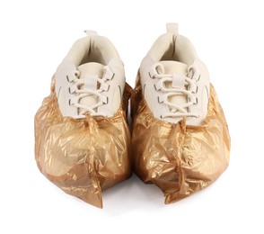 Sneakers in brown shoe covers isolated on white