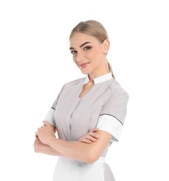 Portrait of young chambermaid in tidy uniform on white background