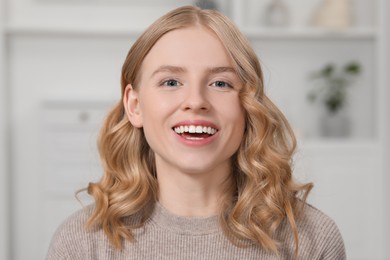 Portrait of beautiful woman with blonde hair indoors