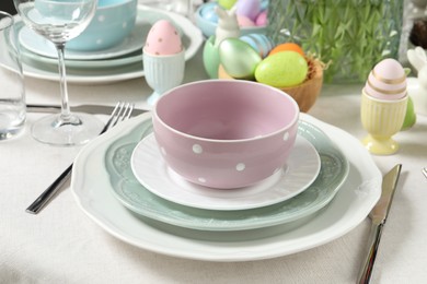 Photo of Easter celebration. Festive table setting with painted eggs.