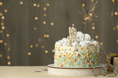 Photo of Beautiful birthday cake with festive decor on white table. Space for text