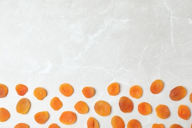 Photo of Flat lay composition with apricots on grey background, space for text. Dried fruit as healthy food