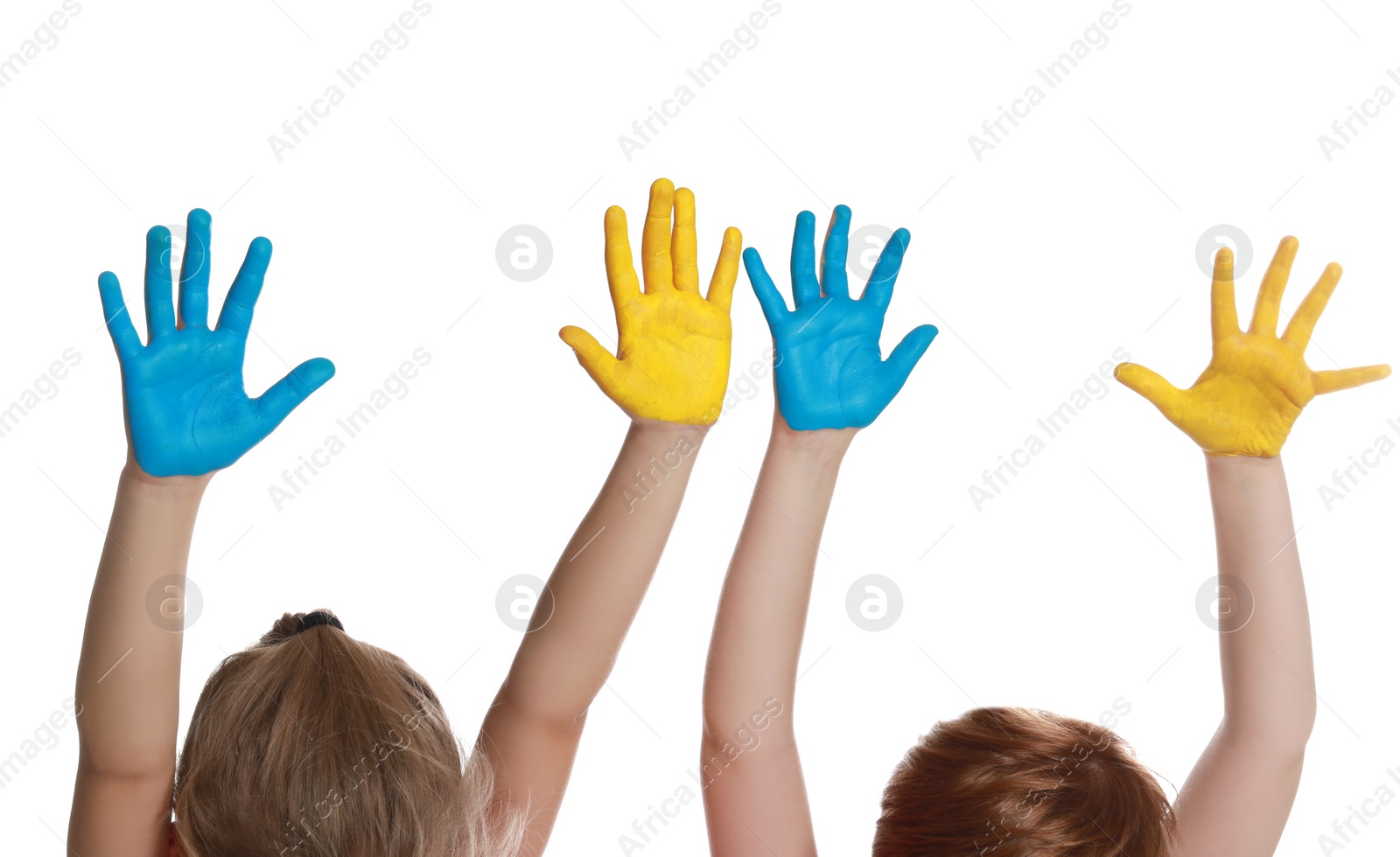 Photo of Little girl and boy with hands painted in Ukrainian flag colors on white background, closeup. Love Ukraine concept