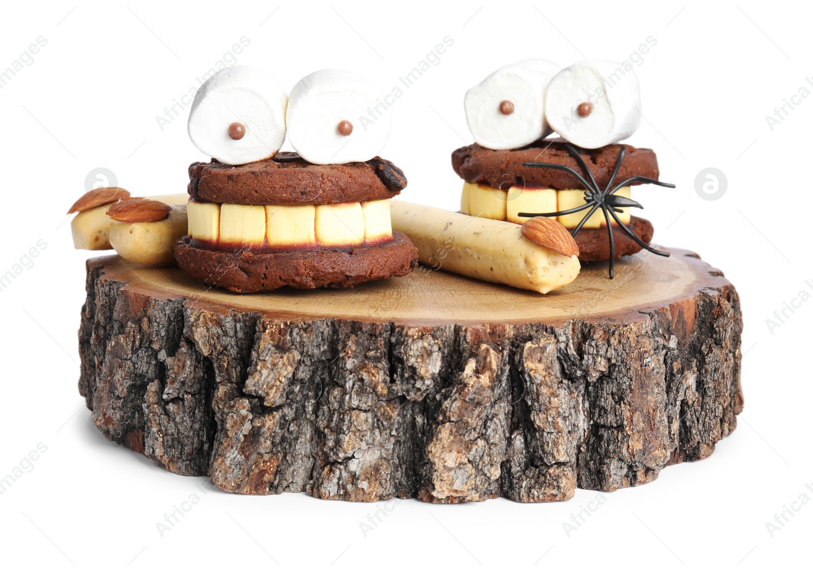 Photo of Delicious desserts decorated as monsters on white background. Halloween treat