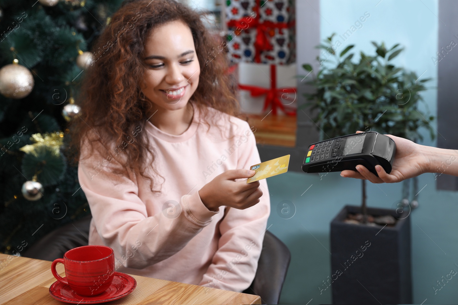 Photo of Client using credit card machine for non cash payment in cafe