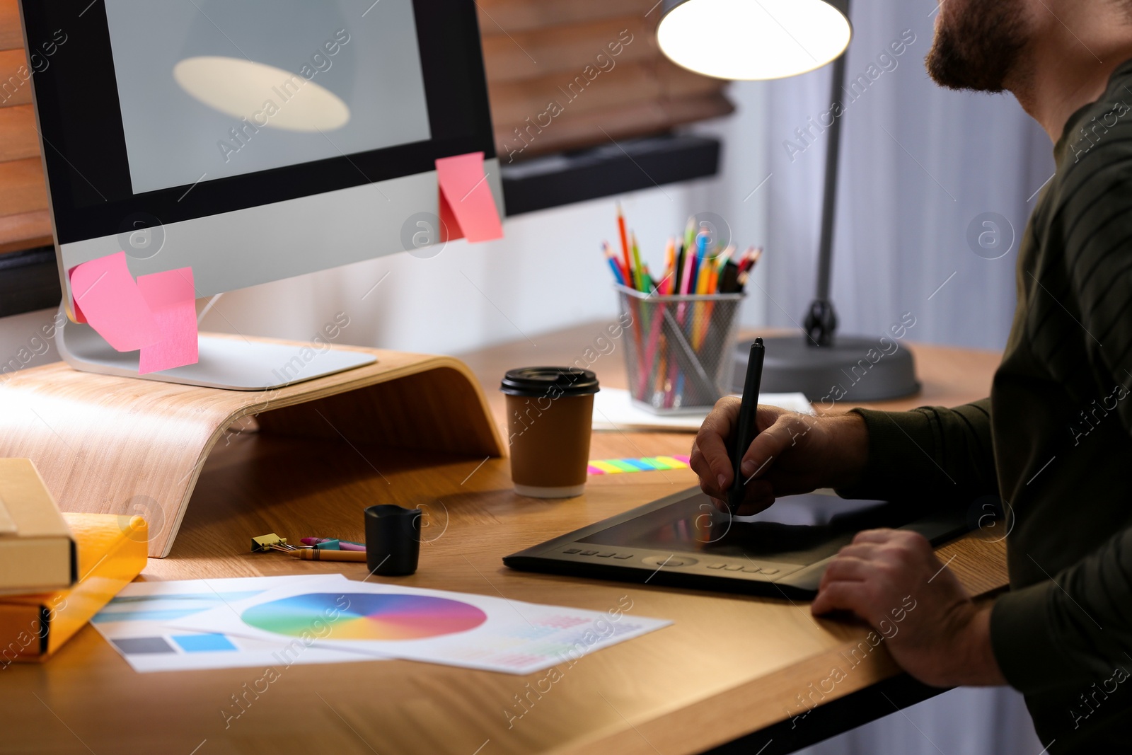 Photo of Male designer working at desk in office, closeup