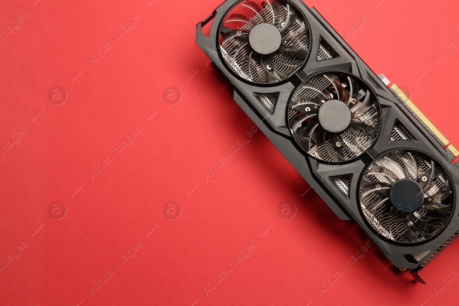 Photo of One graphics card on red background, top view. Space for text