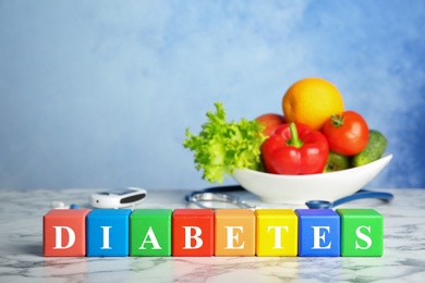 Photo of Color blocks and healthy food on table. Diabetes concept