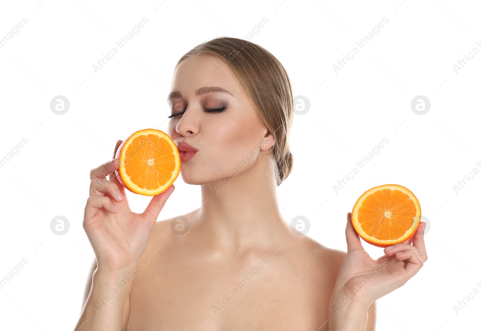 Photo of Young woman with cut orange on white background. Vitamin rich food