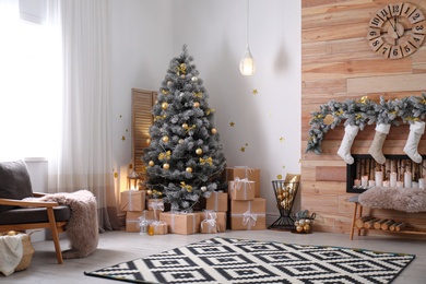 Photo of Stylish room interior with beautiful Christmas tree and decorative fireplace