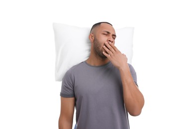 Photo of Tired man with pillow yawning on white background. Insomnia problem